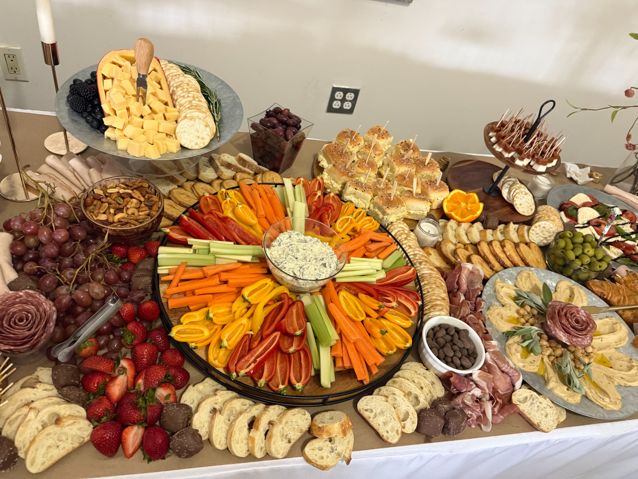 Grazing table with cheeses, meats, fruit and flowers